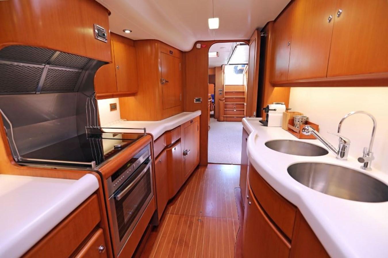 a kitchen with wooden cabinets aboard NIMROD Yacht for Sale