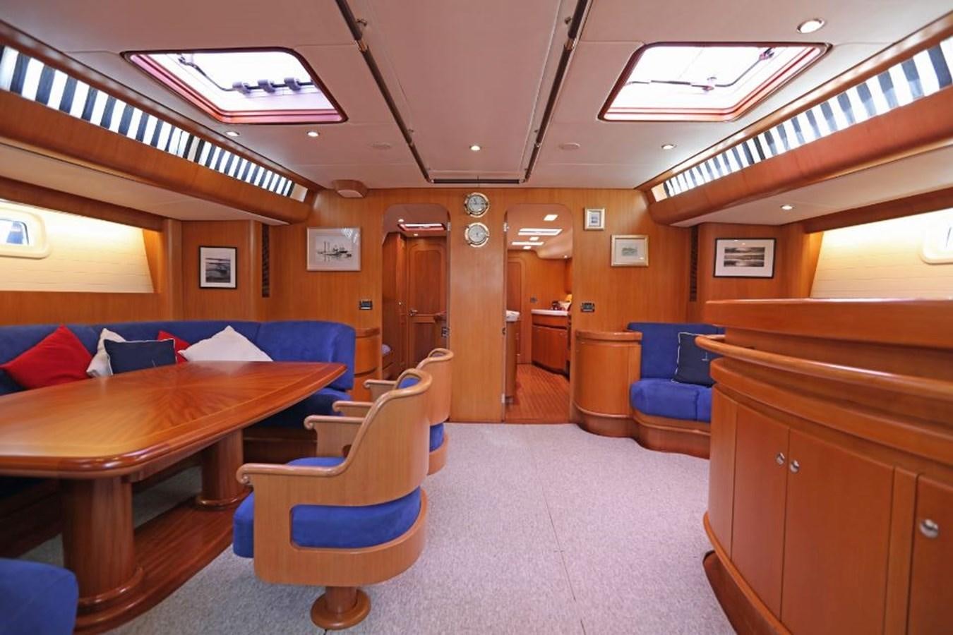 a room with a table chairs and a bench aboard NIMROD Yacht for Sale