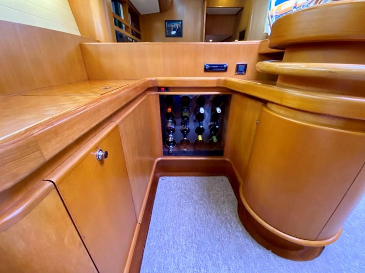 a group of bottles in a cabinet aboard NIMROD Yacht for Sale