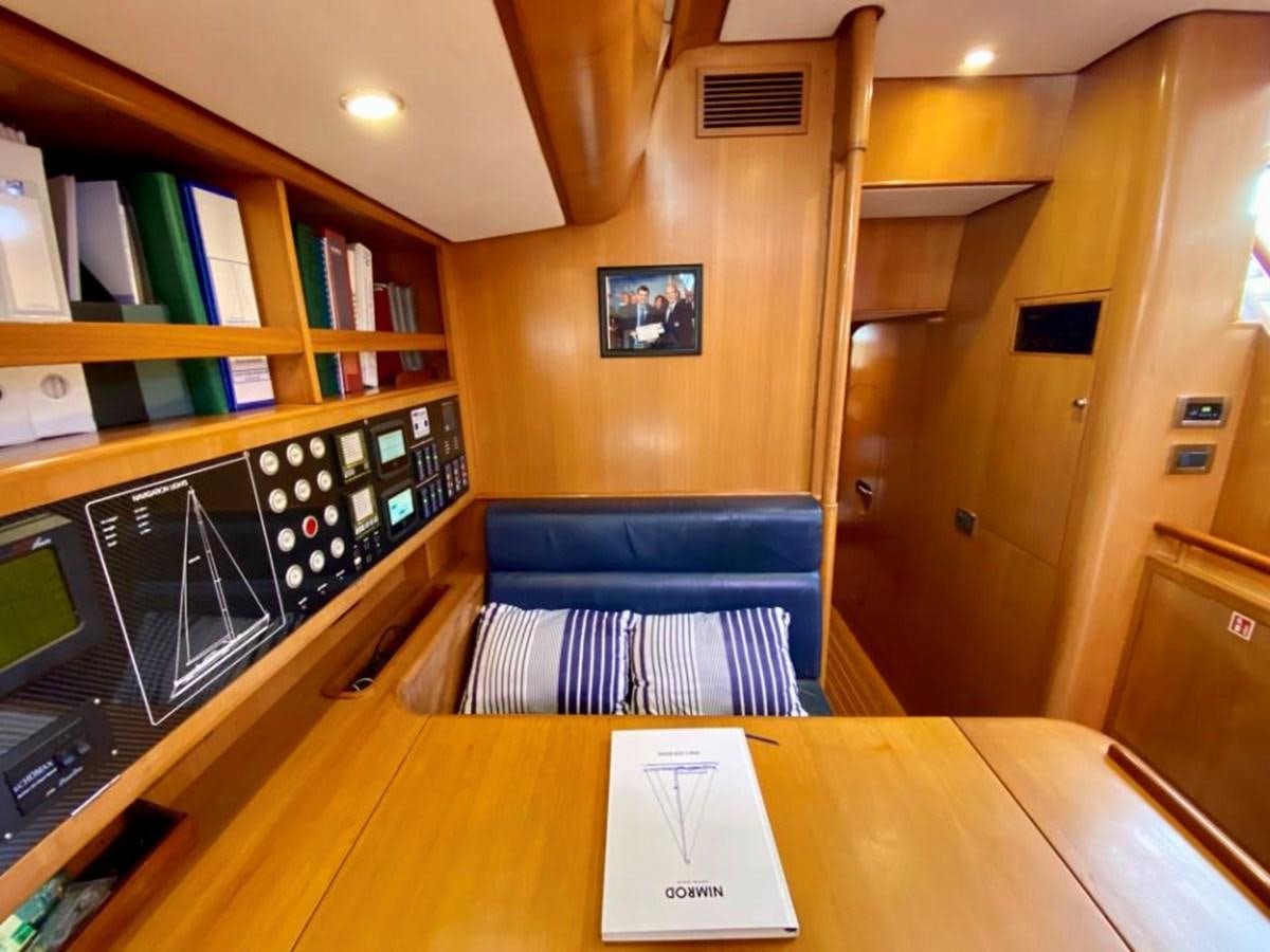 a room with a desk and a book shelf aboard NIMROD Yacht for Sale