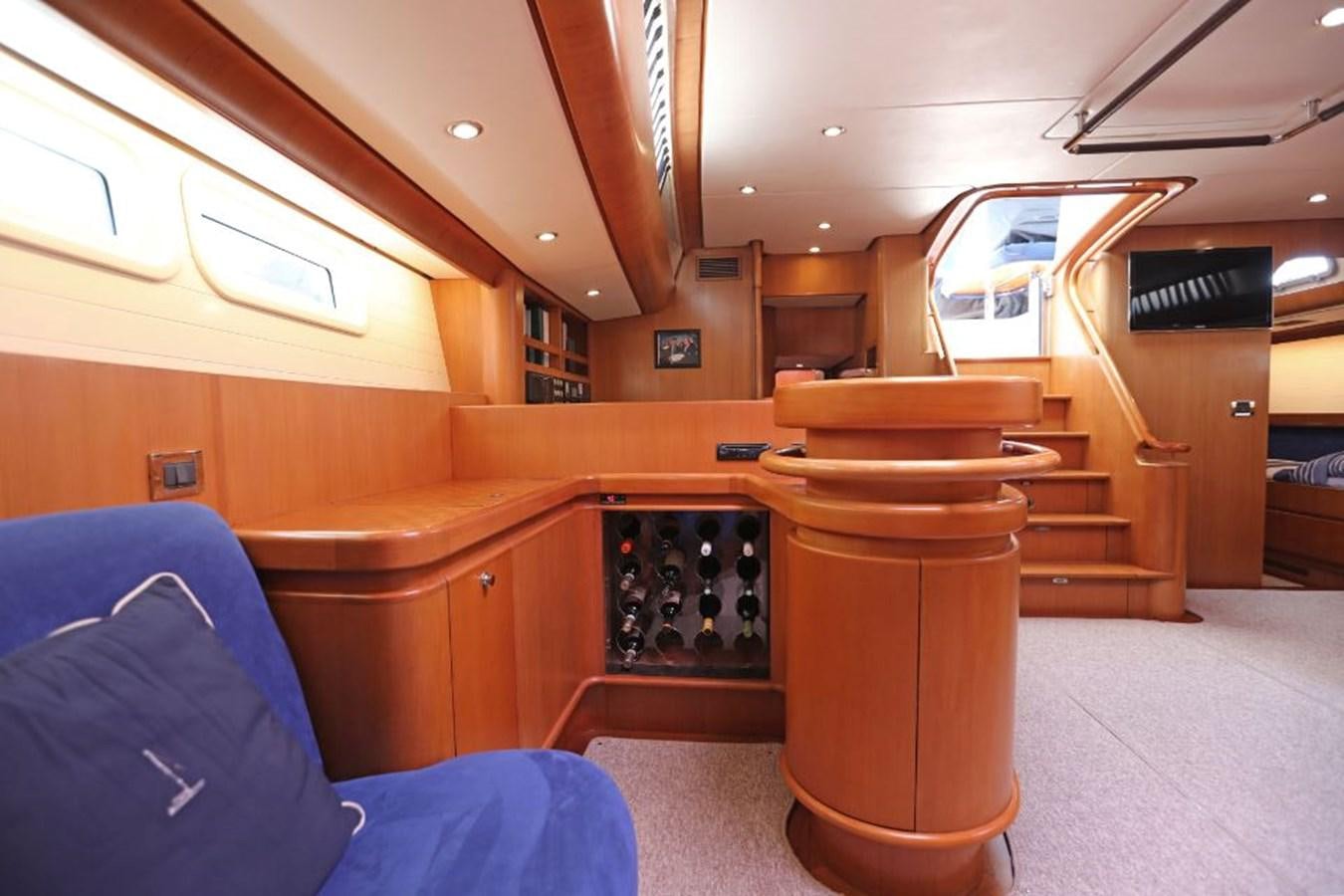 a room with a wood table and a chair and a ladder aboard NIMROD Yacht for Sale