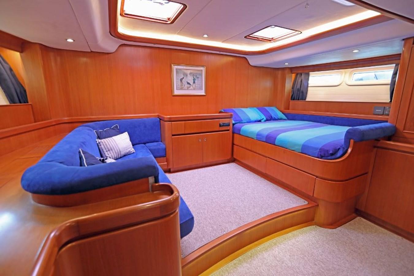 a cabin with a bed and a couch aboard NIMROD Yacht for Sale
