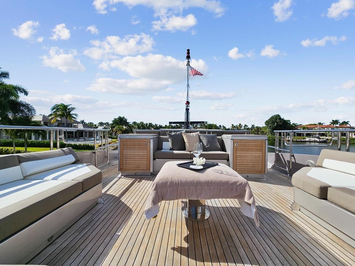 a deck with a flag and a body of water aboard IZUMI Yacht for Sale