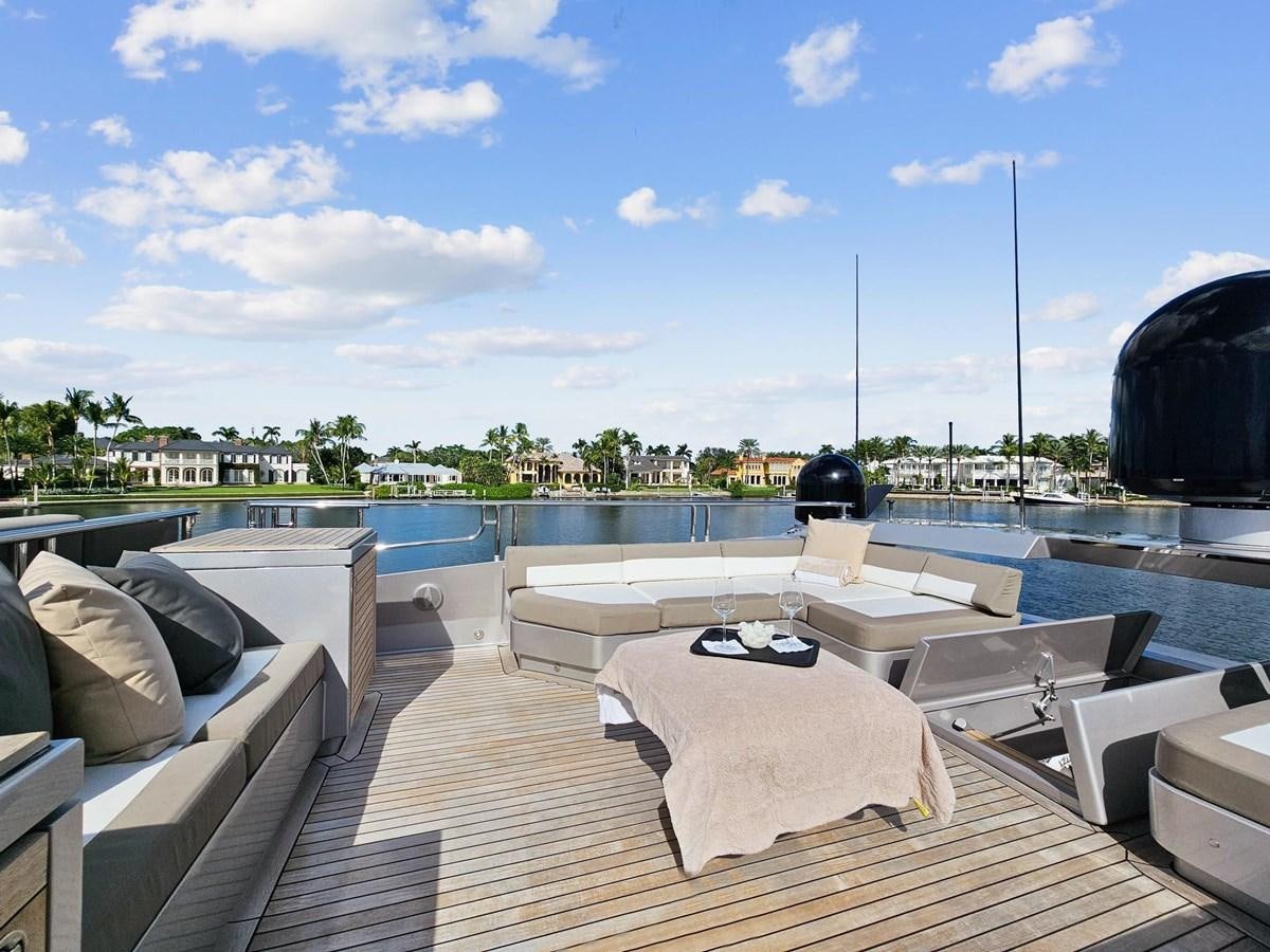 a deck with a pool and a view of a city aboard IZUMI Yacht for Sale