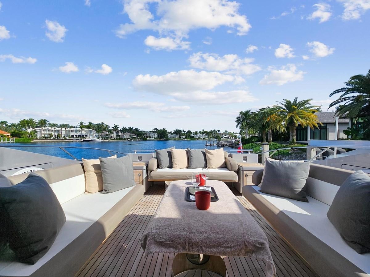 a patio with a pool and a deck with chairs and a table aboard IZUMI Yacht for Sale
