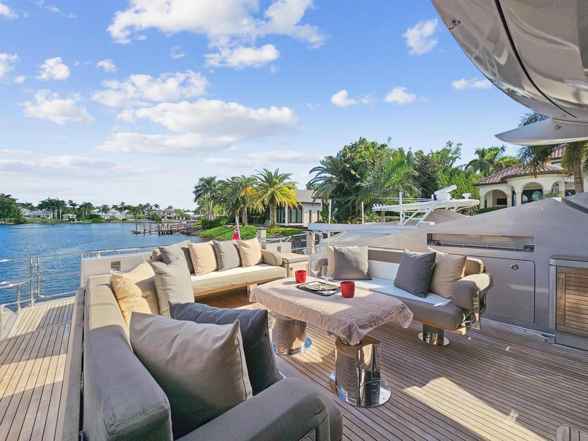 a deck with a table and chairs on it aboard IZUMI Yacht for Sale