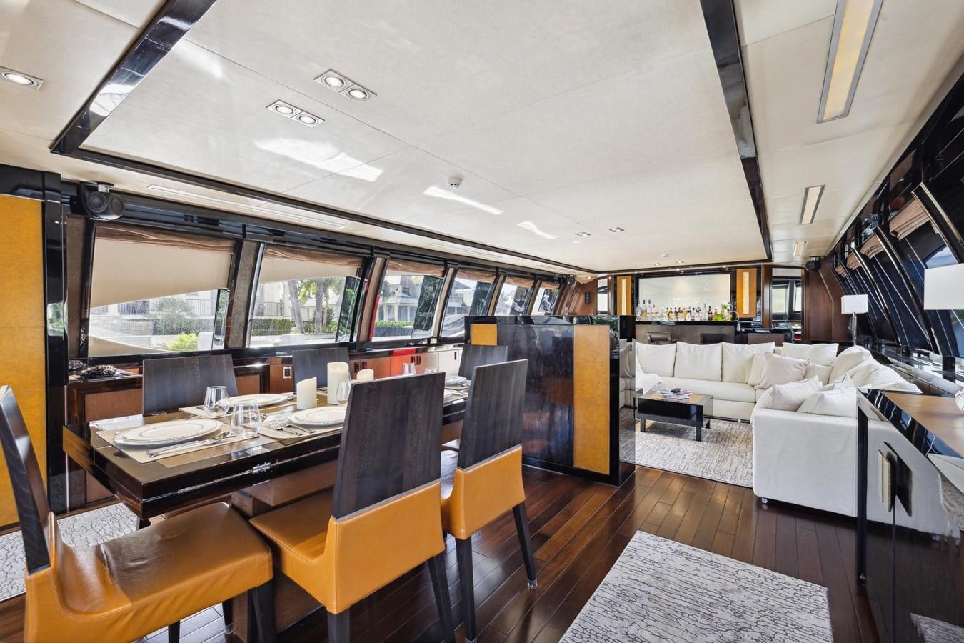 a room with a table chairs and a couch aboard IZUMI Yacht for Sale