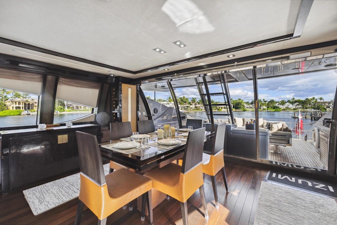 a dining table in a room aboard IZUMI Yacht for Sale