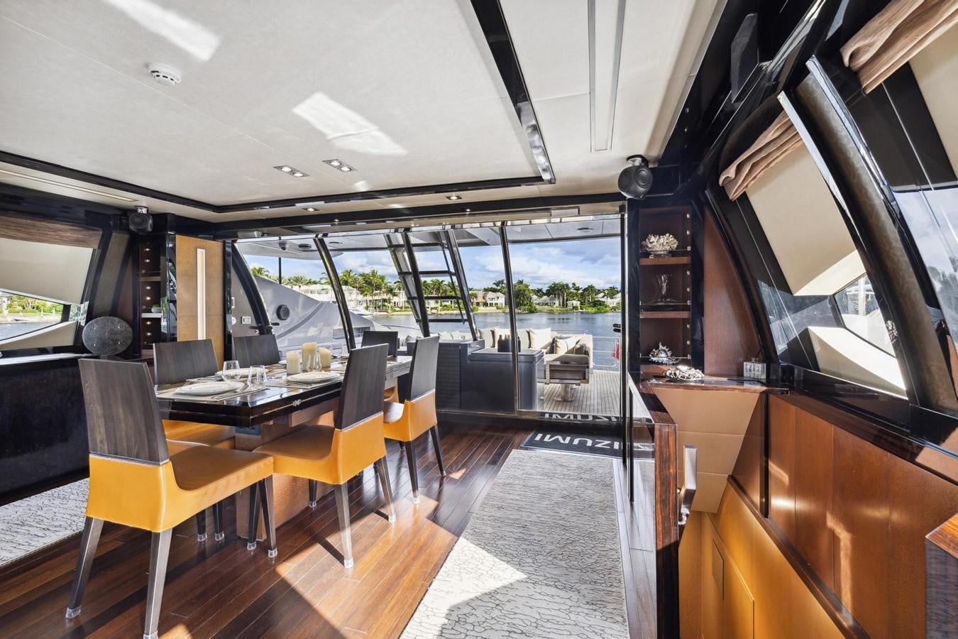 inside of a building with a table and chairs and a large window aboard IZUMI Yacht for Sale