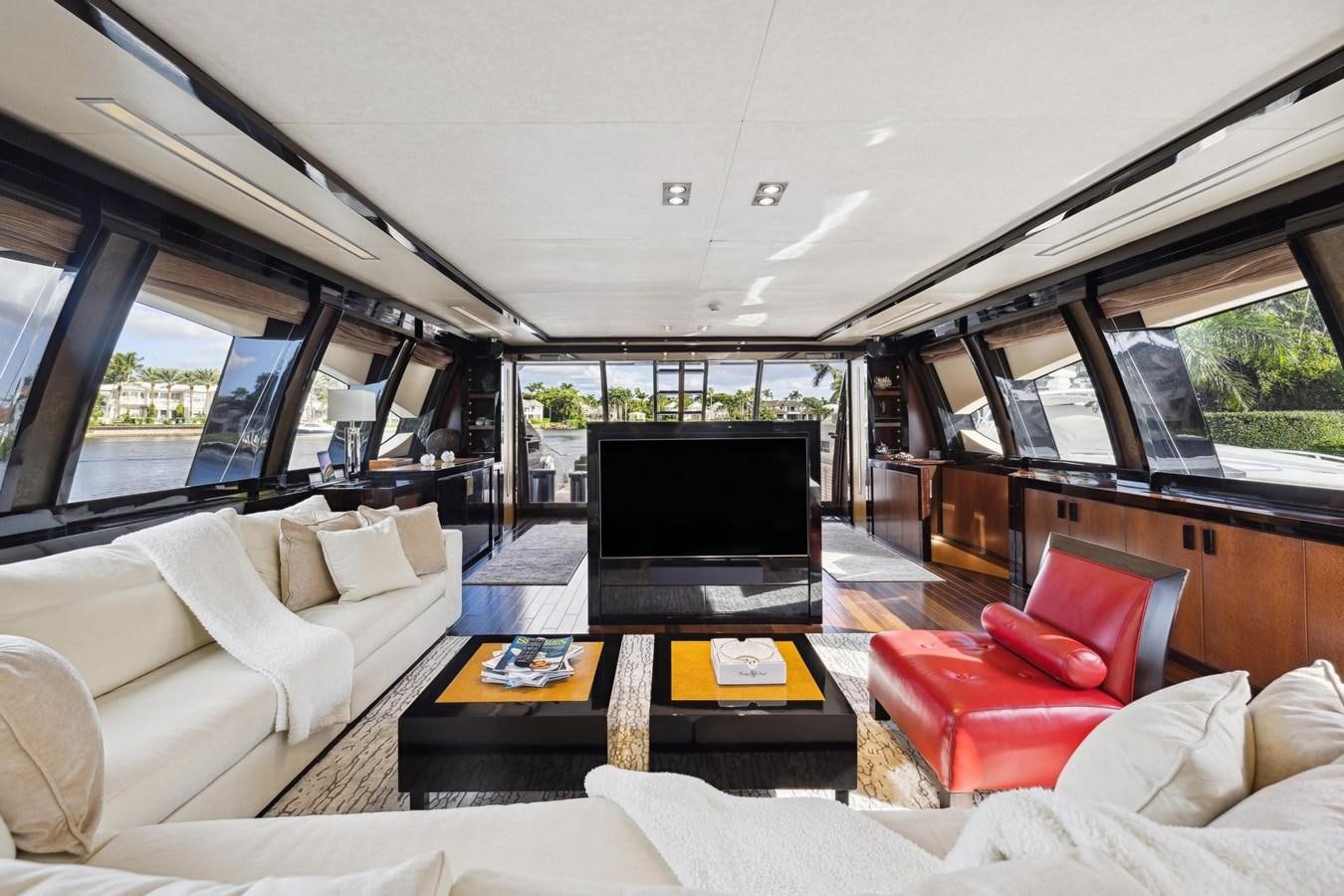 a living room with a tv and couches aboard IZUMI Yacht for Sale