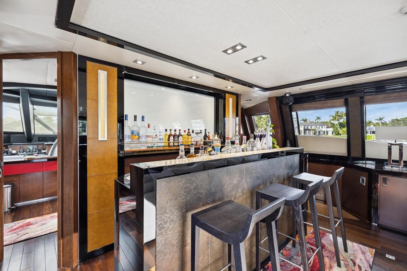 a bar with a bar and stools aboard IZUMI Yacht for Sale