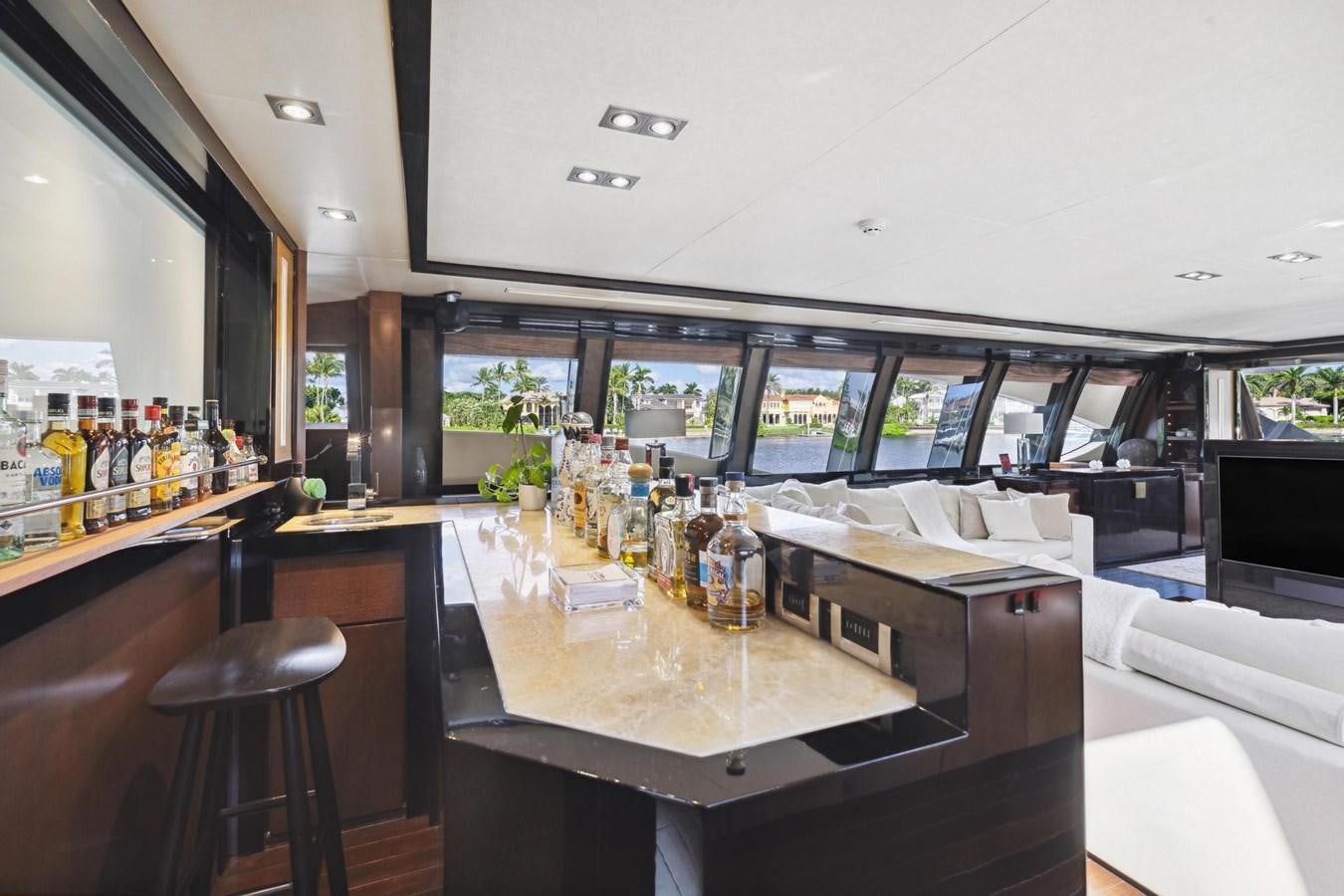 a room with a table and a tv aboard IZUMI Yacht for Sale