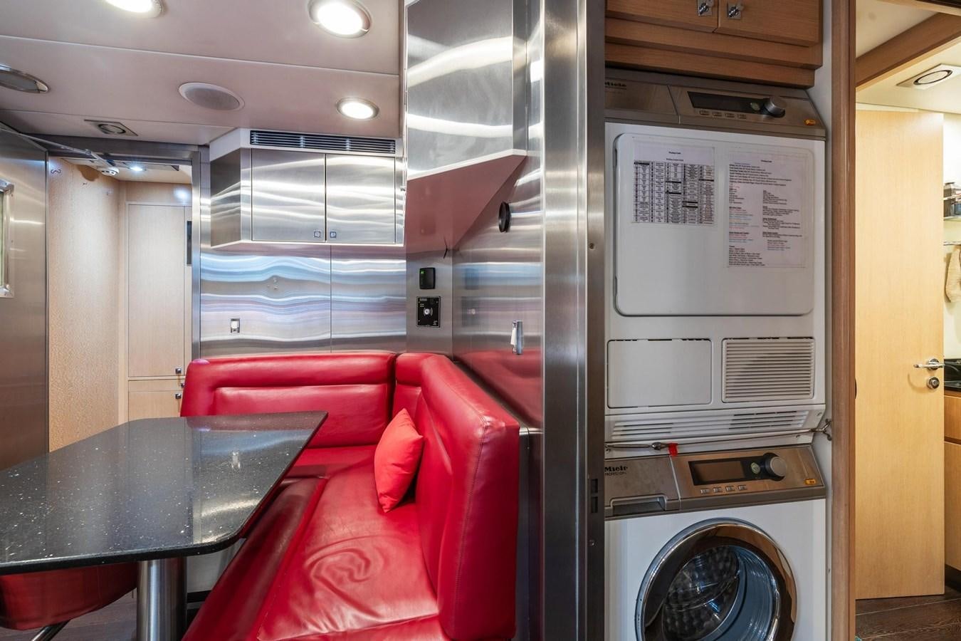 a room with a table and chairs aboard IZUMI Yacht for Sale