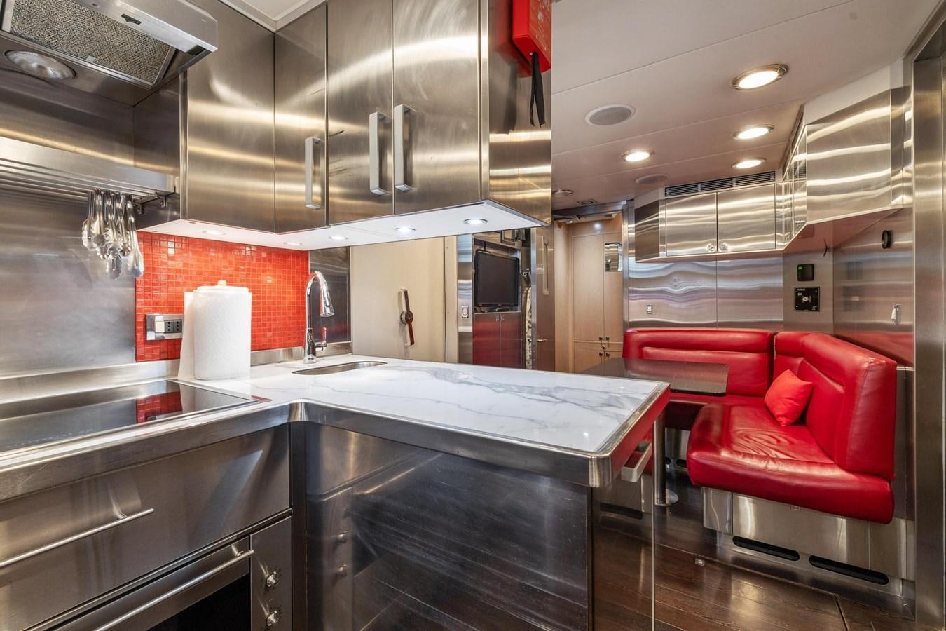 a kitchen with stainless steel appliances aboard IZUMI Yacht for Sale