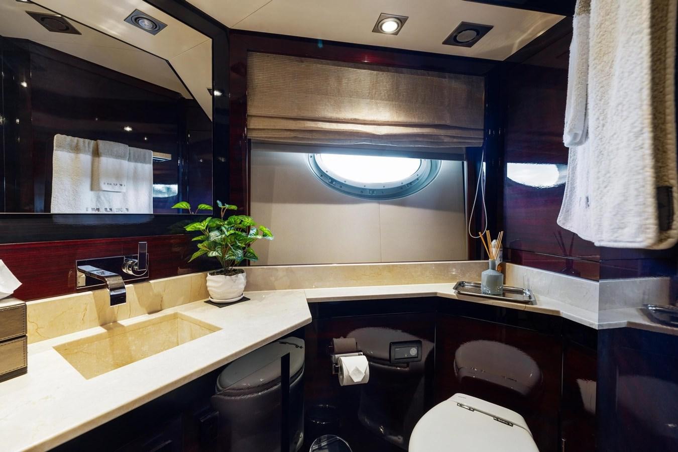 a bathroom with a sink and a mirror aboard IZUMI Yacht for Sale