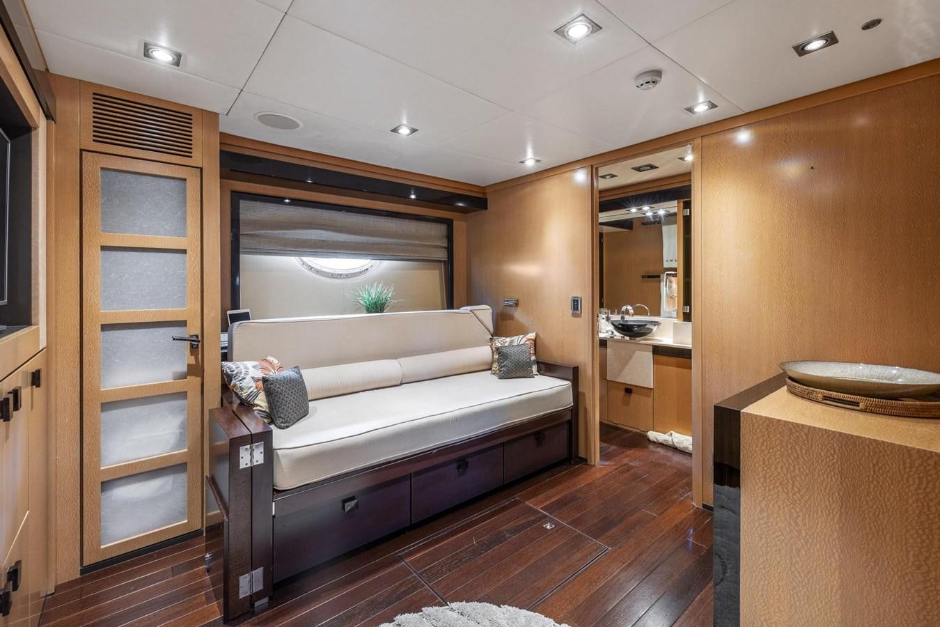 a bedroom with a bed and a mirror aboard IZUMI Yacht for Sale