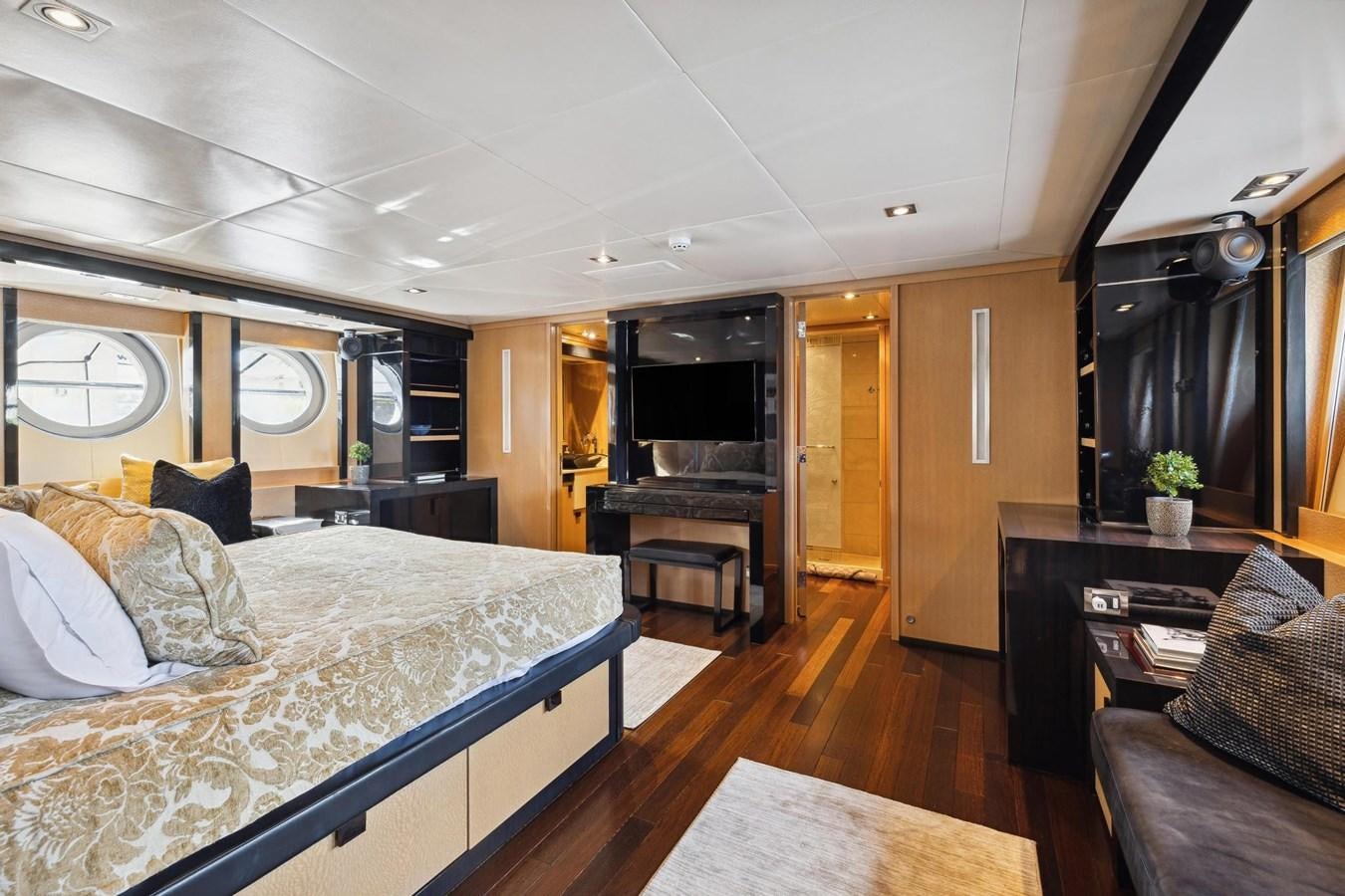 a bedroom with a bed and piano aboard IZUMI Yacht for Sale