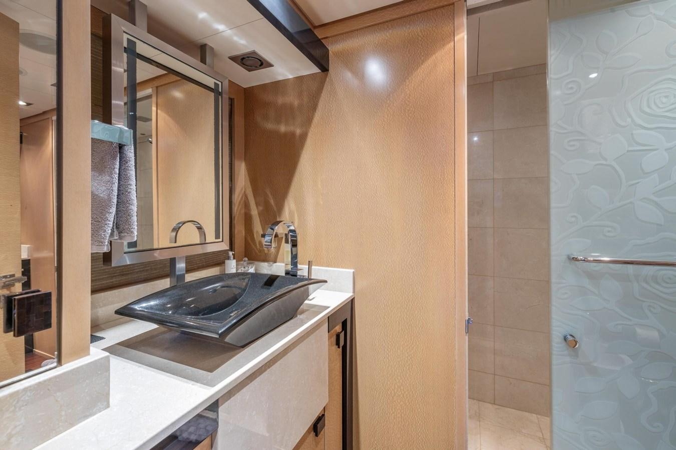 a bathroom with a large mirror aboard IZUMI Yacht for Sale