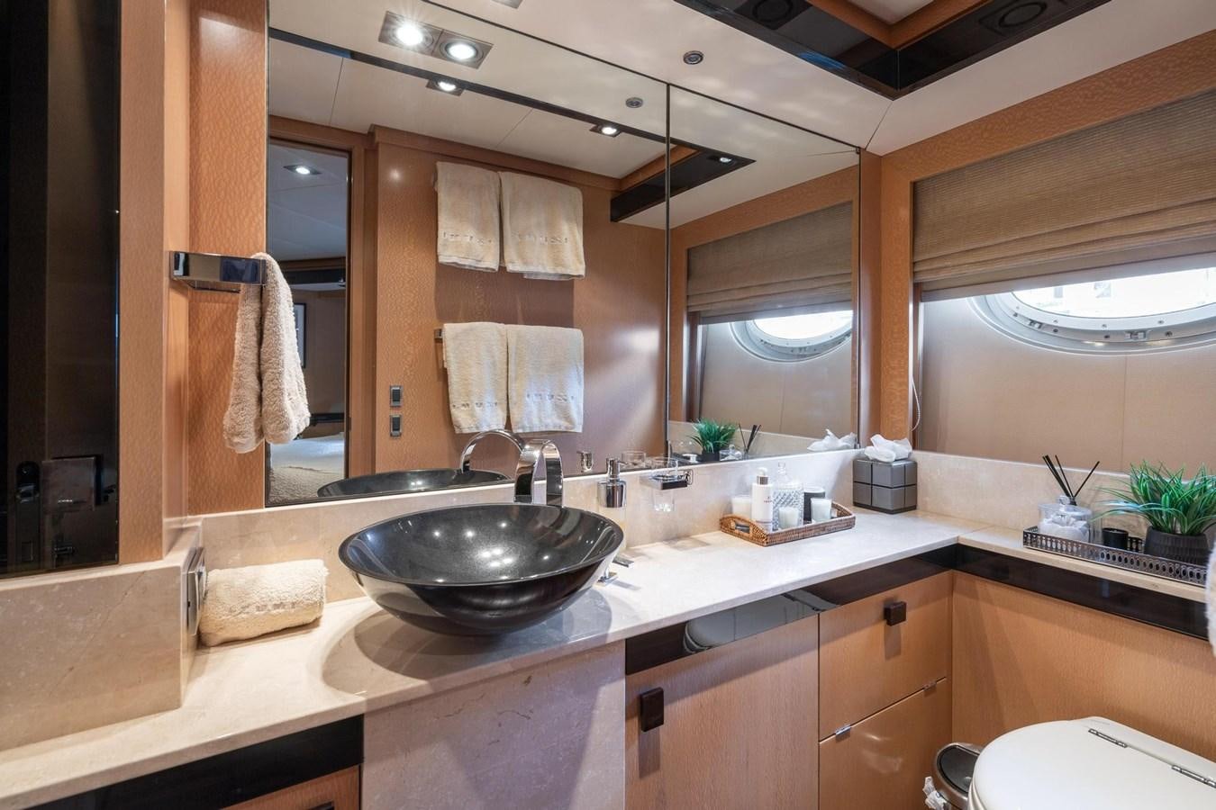 a bathroom with a sink and a large mirror aboard IZUMI Yacht for Sale