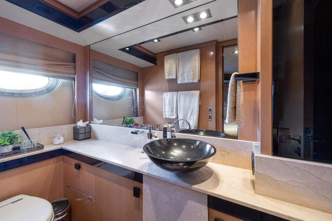 a bathroom with a sink and a mirror aboard IZUMI Yacht for Sale