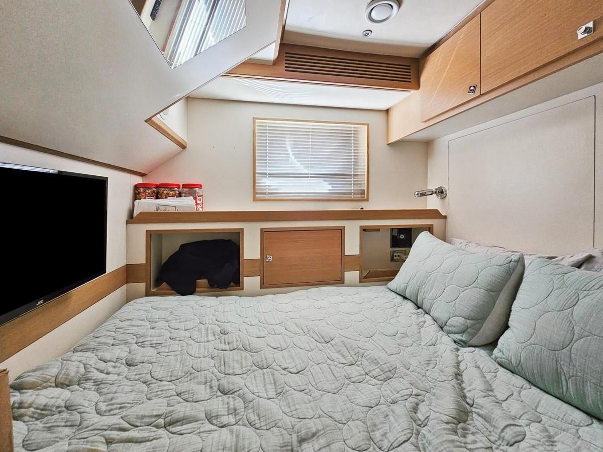 a bed with a white sheet aboard IZUMI Yacht for Sale