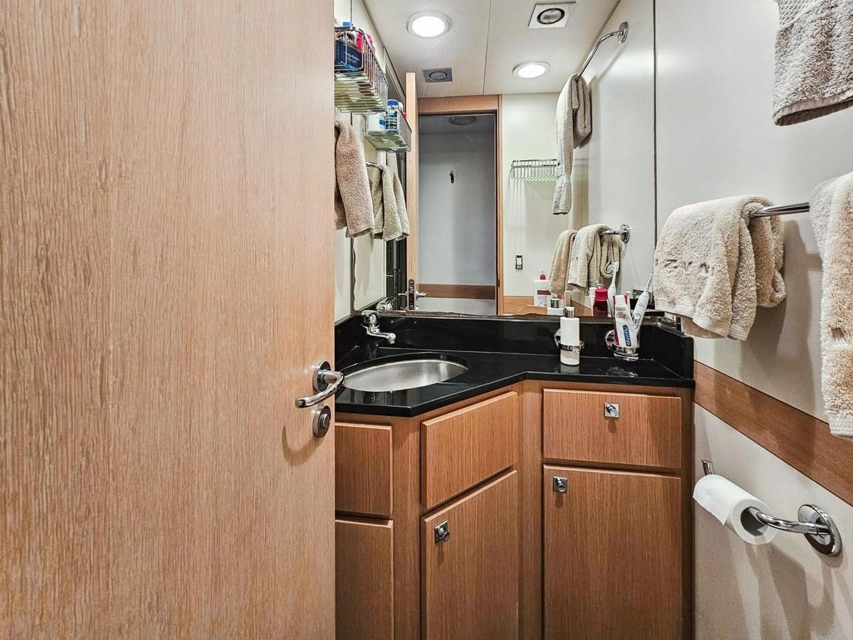 a bathroom with a sink and a mirror aboard IZUMI Yacht for Sale