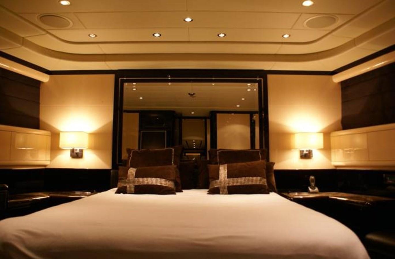 a hotel room with a bed and a large mirror aboard ENZO Yacht for Sale