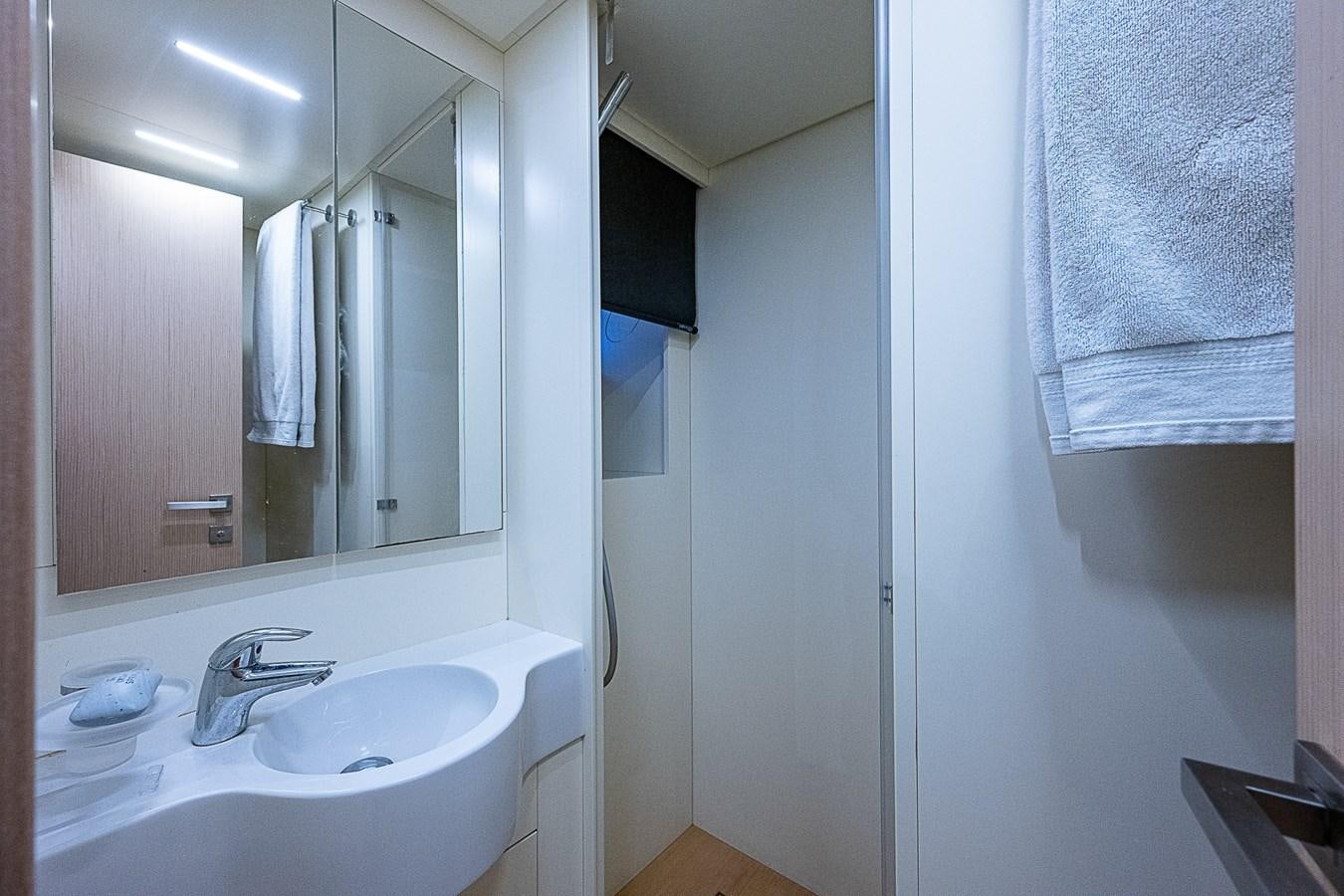 a bathroom with a sink and a mirror aboard DANDY 2021 FERRETTI 850 @ AVENTURA Yacht for Sale