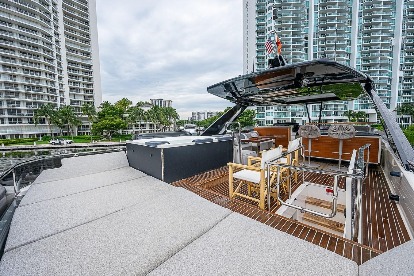 a deck with chairs and a building in the background aboard DANDY 2021 FERRETTI 850 @ AVENTURA Yacht for Sale