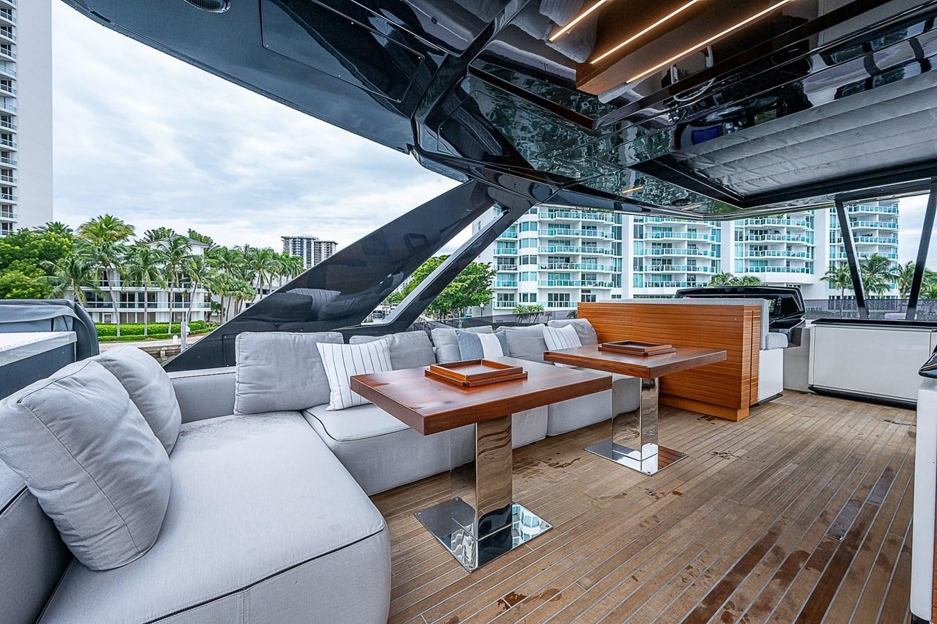 a room with a couch and a table and a large window aboard DANDY 2021 FERRETTI 850 @ AVENTURA Yacht for Sale