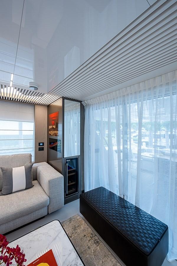 a living room with a blue couch aboard DANDY 2021 FERRETTI 850 @ AVENTURA Yacht for Sale