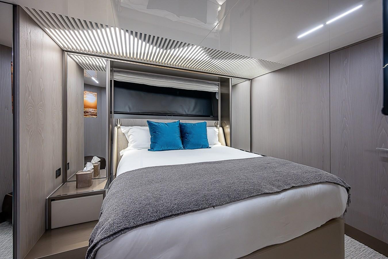 a bed with blue pillows aboard DANDY 2021 FERRETTI 850 @ AVENTURA Yacht for Sale