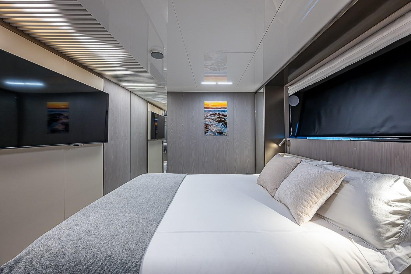 a room with a bed and a television aboard DANDY 2021 FERRETTI 850 @ AVENTURA Yacht for Sale