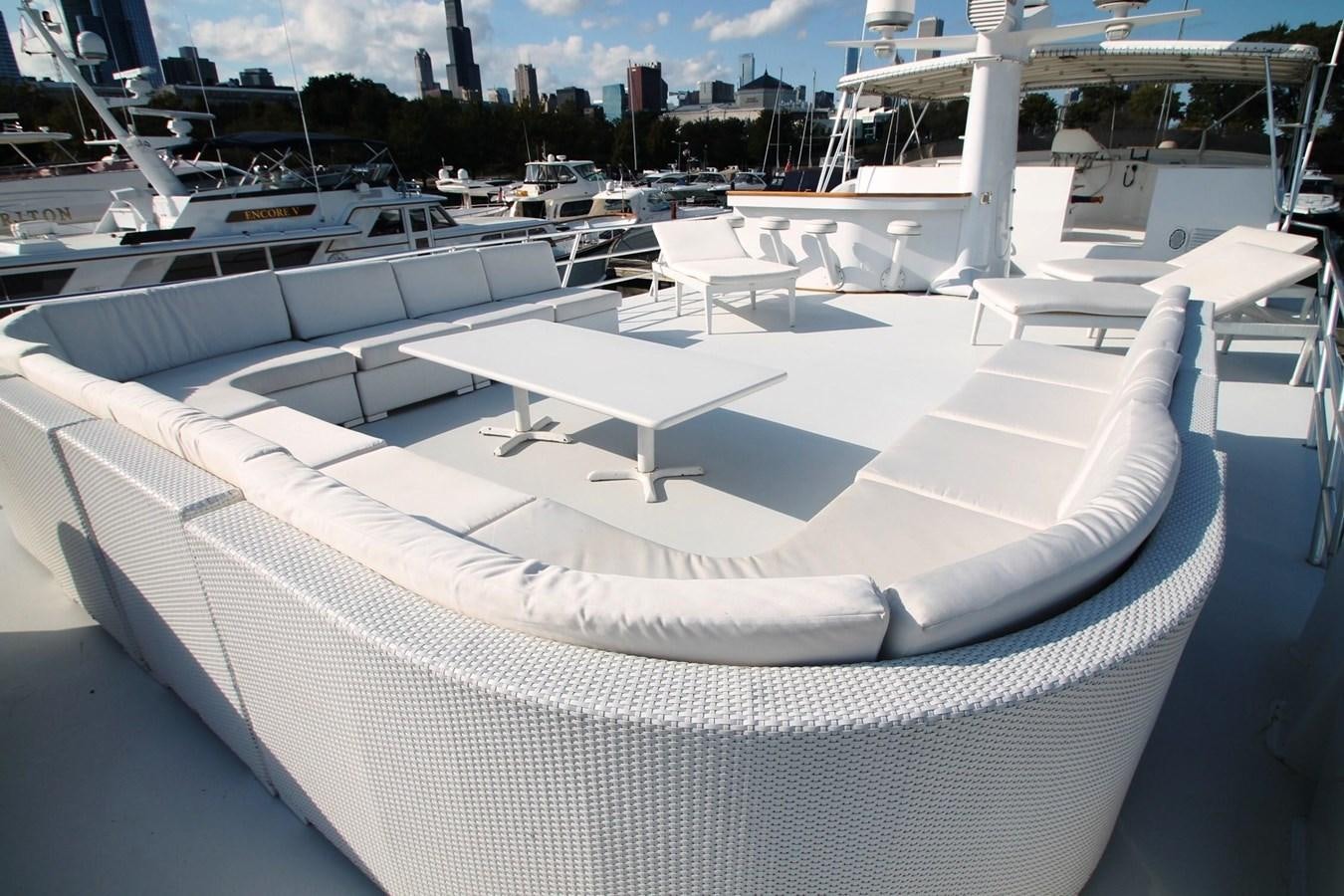 a large group of white lounge chairs aboard ENCHANTRESS Yacht for Sale