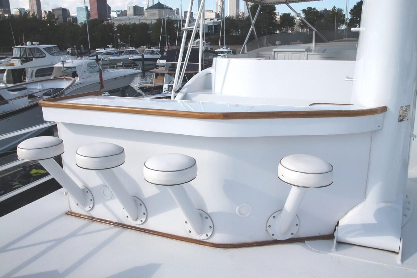 a white boat with a steering wheel aboard ENCHANTRESS Yacht for Sale