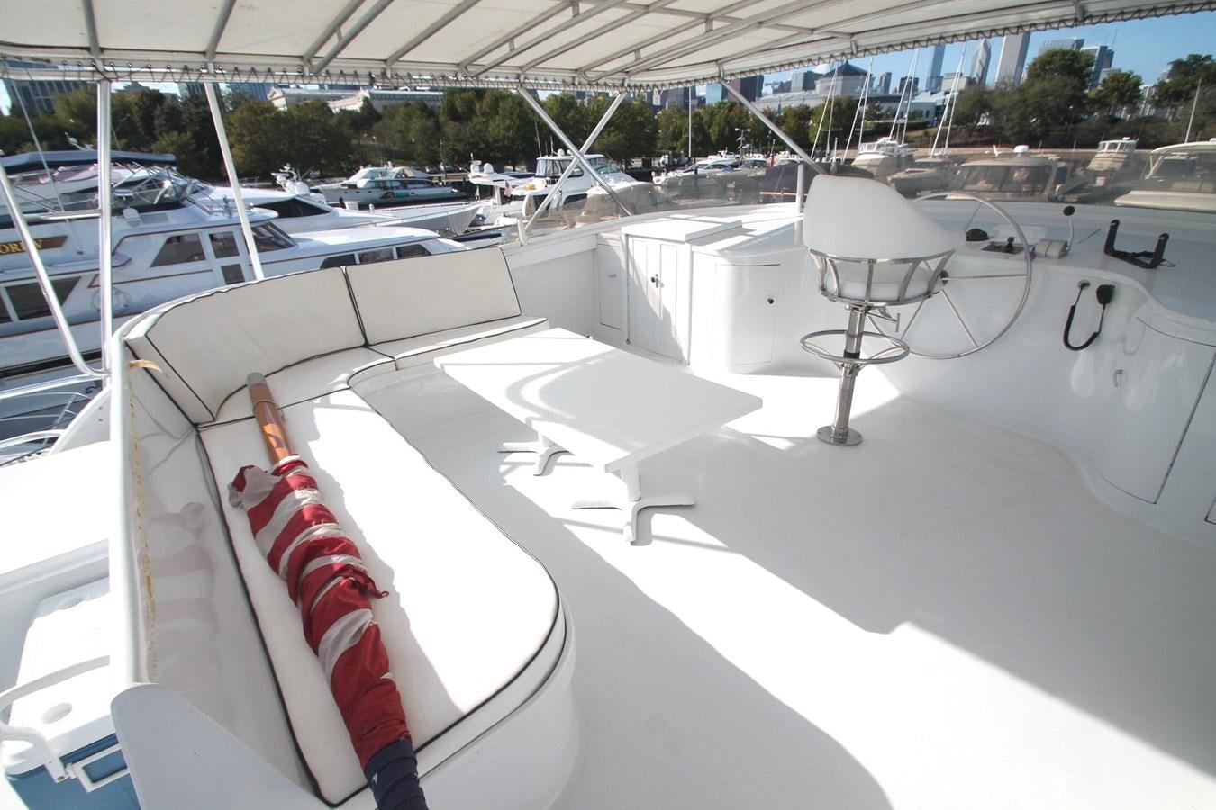 a white table with chairs on it aboard ENCHANTRESS Yacht for Sale