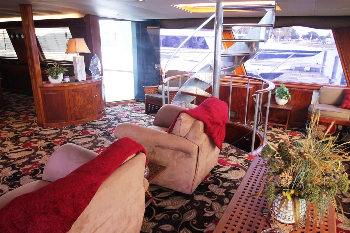 a living room with a view of the ocean aboard ENCHANTRESS Yacht for Sale
