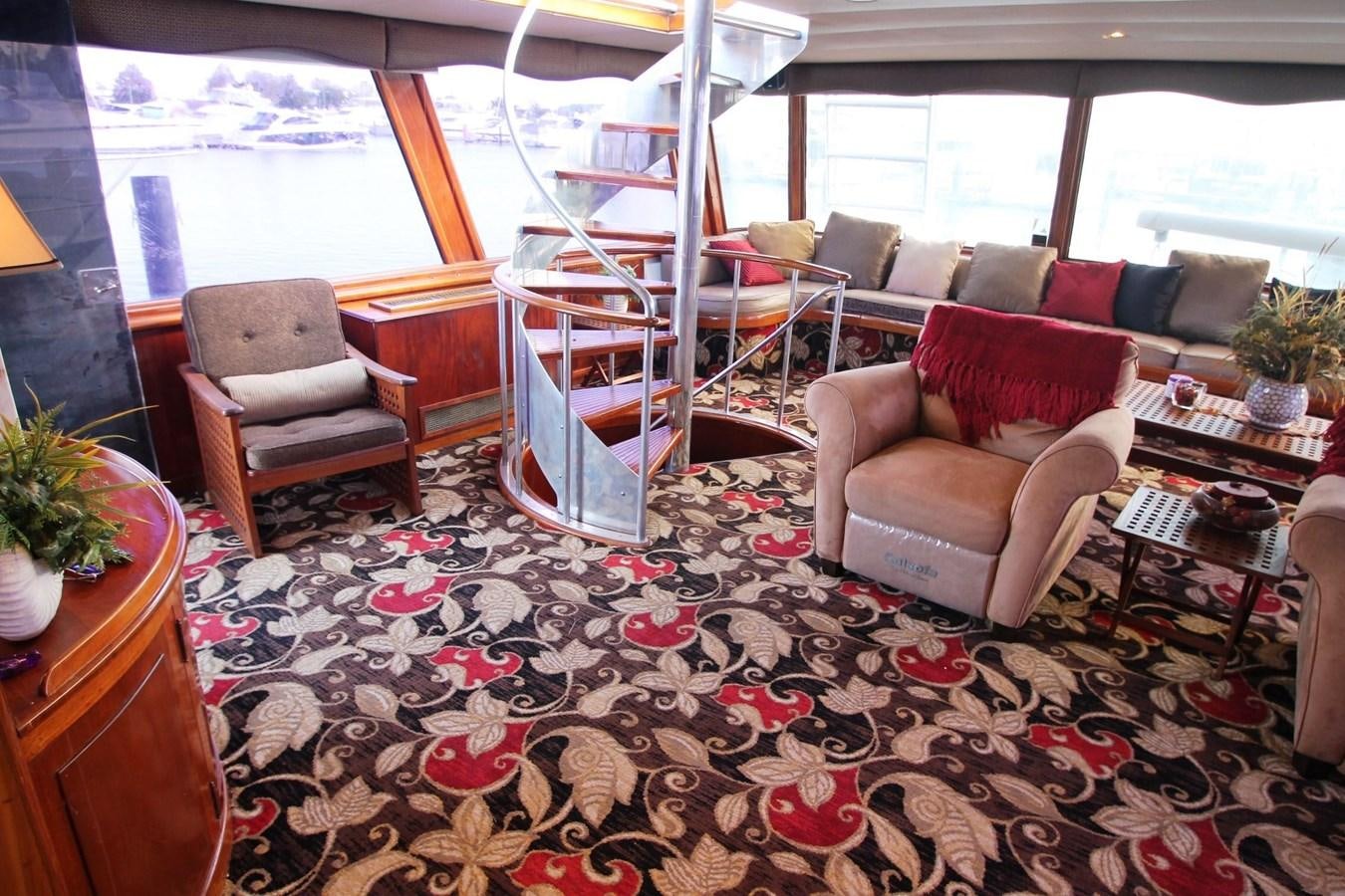 a living room with a ladder and chairs aboard ENCHANTRESS Yacht for Sale