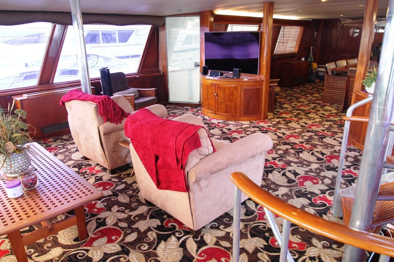 a living room with a couch and a television aboard ENCHANTRESS Yacht for Sale