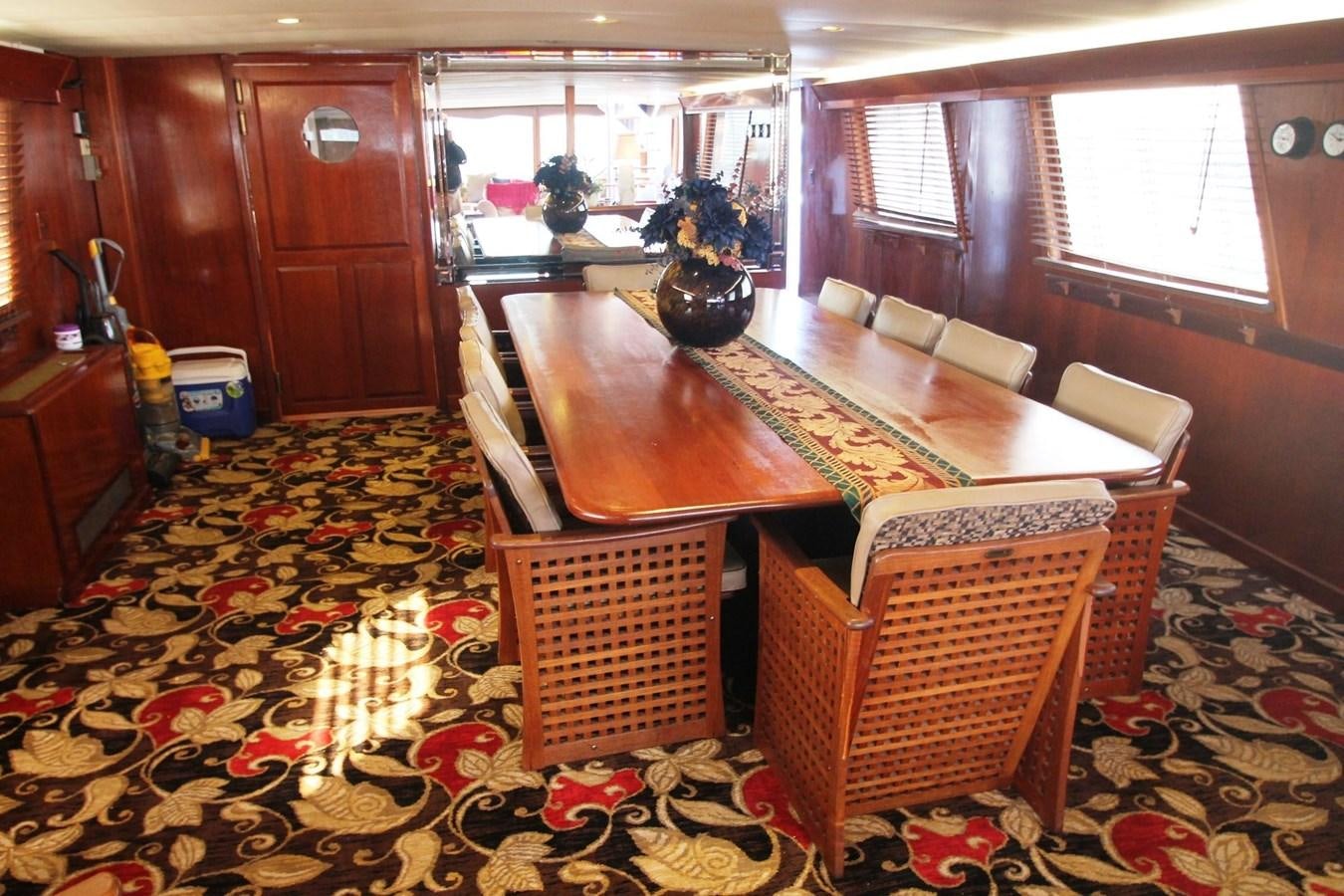 a living room with a table and chairs aboard ENCHANTRESS Yacht for Sale