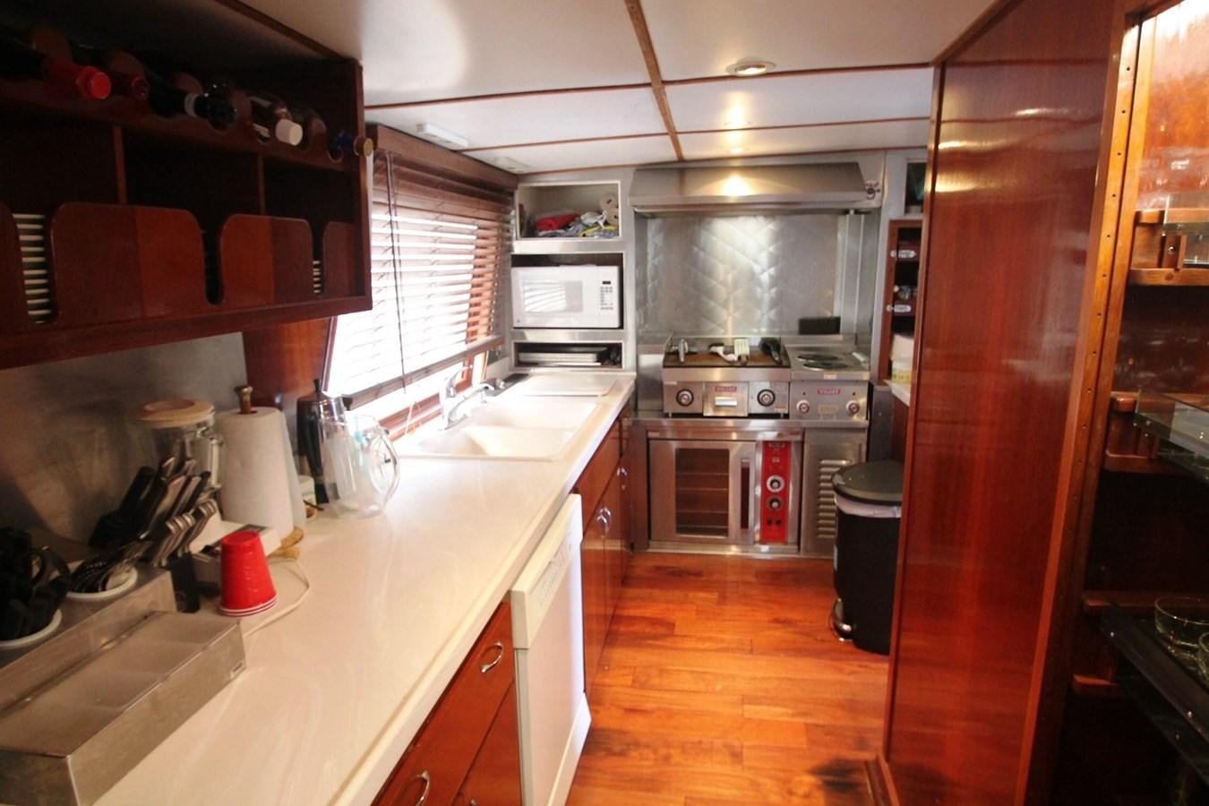 a kitchen with a sink and stove aboard ENCHANTRESS Yacht for Sale