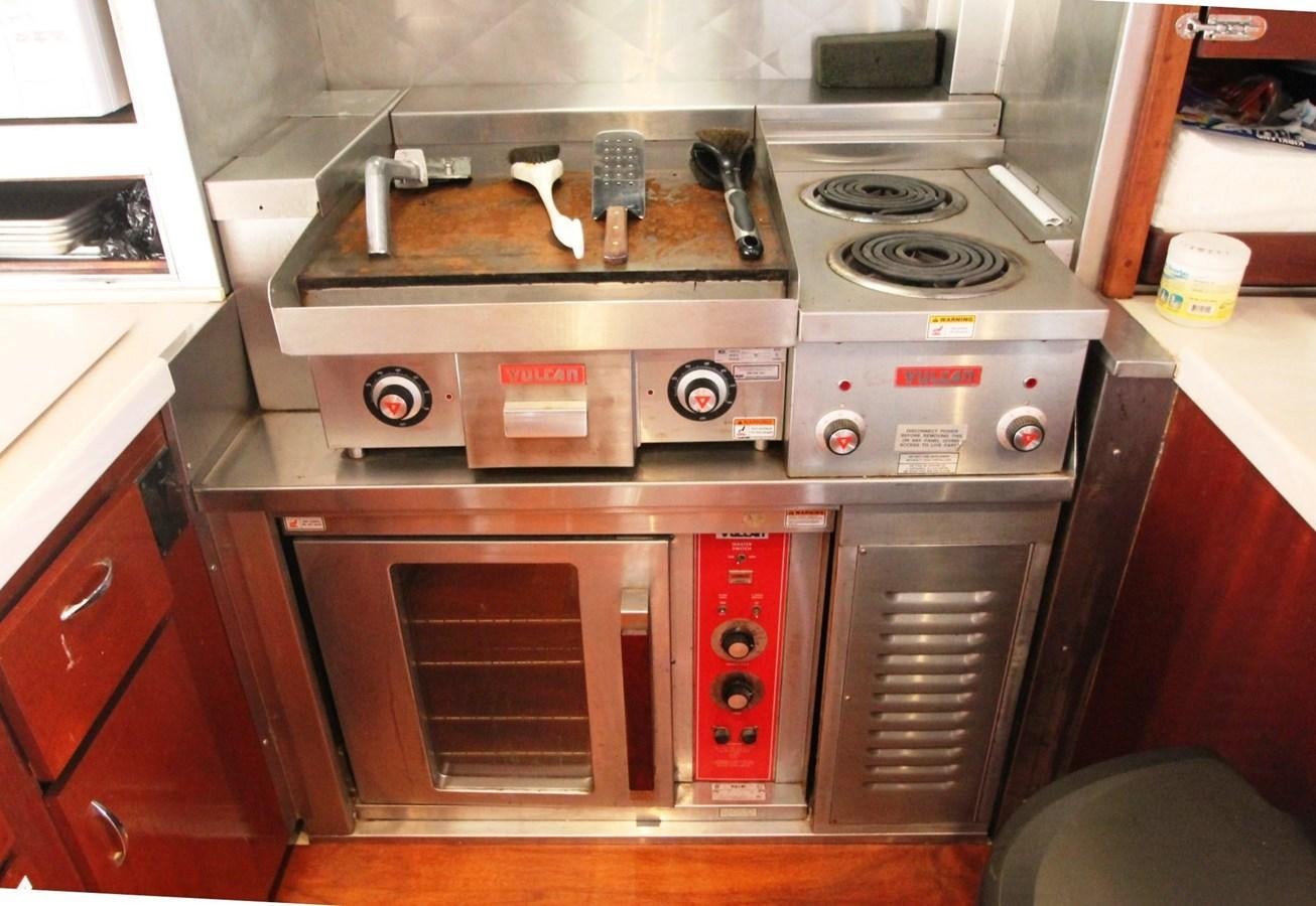 a stove with a pan on it aboard ENCHANTRESS Yacht for Sale