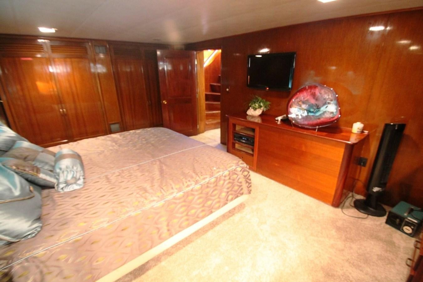 a bedroom with a bed and a television aboard ENCHANTRESS Yacht for Sale