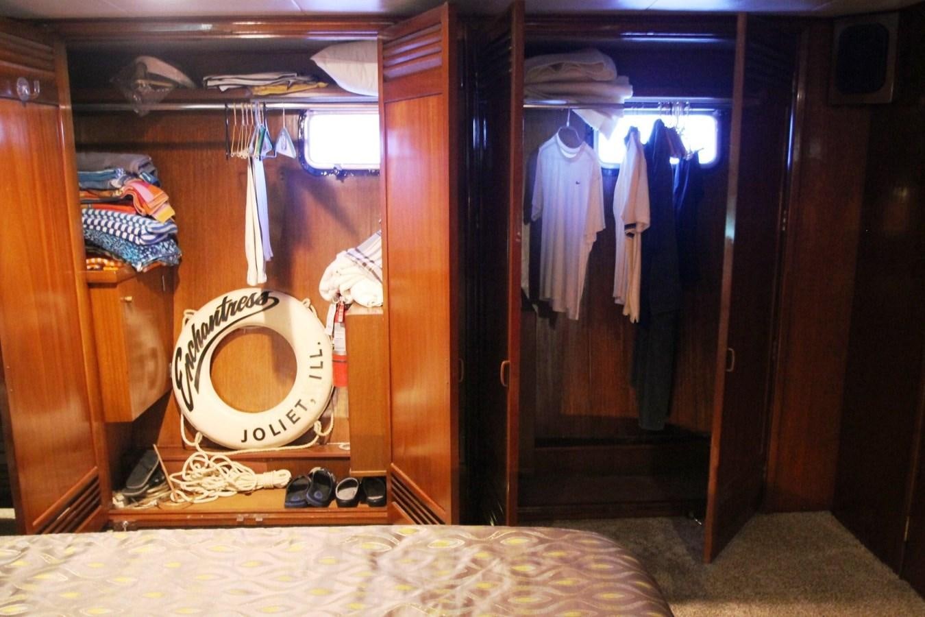 a closet with clothes and clothes aboard ENCHANTRESS Yacht for Sale