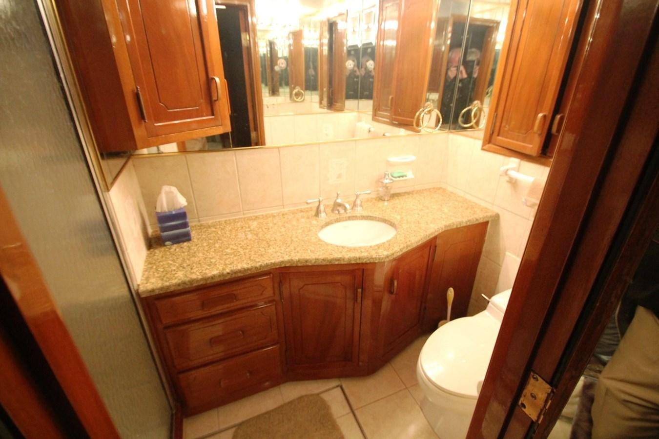a bathroom with a countertop sink and cabinets aboard ENCHANTRESS Yacht for Sale