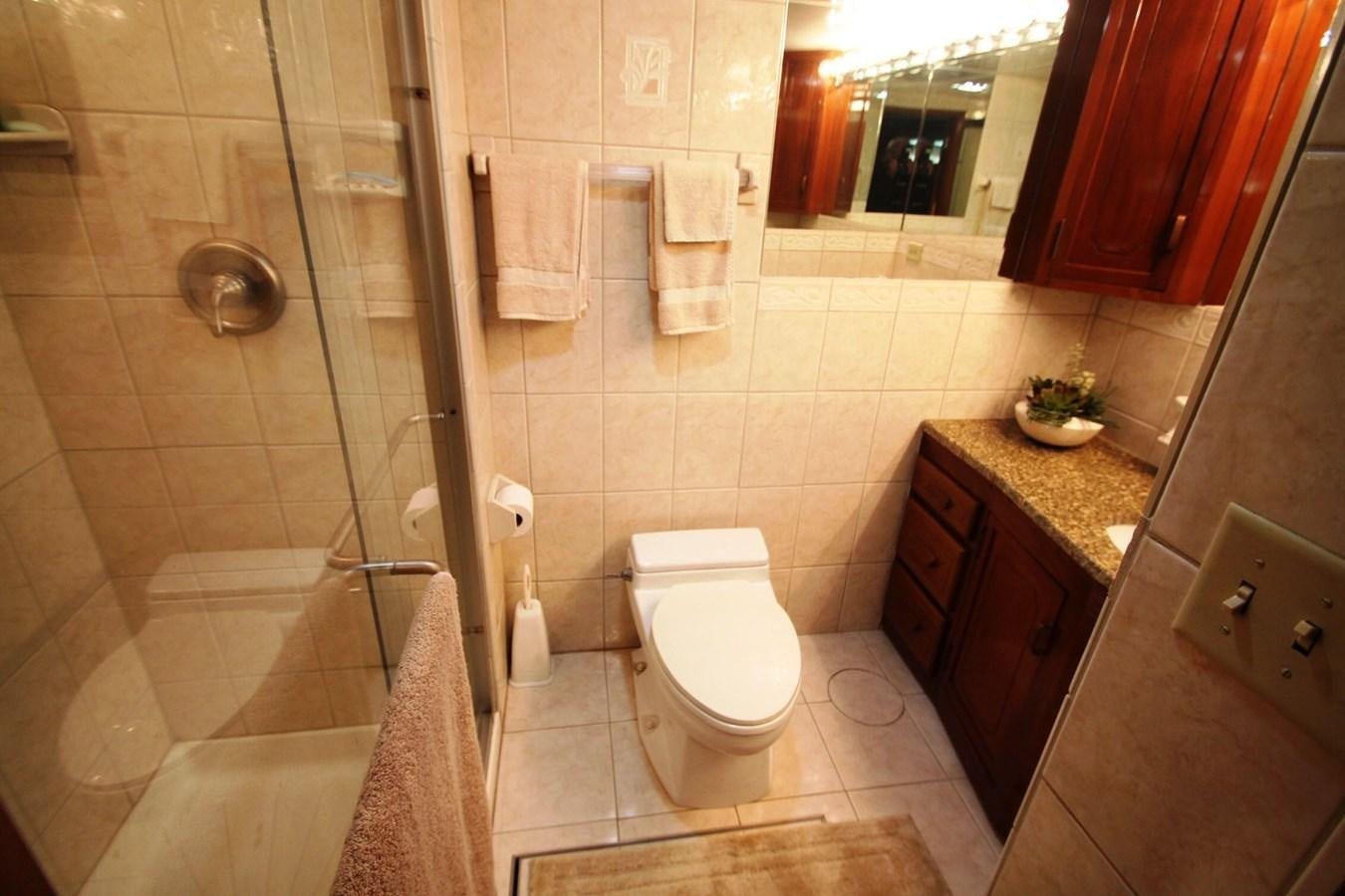 a bathroom with a toilet and bathtub aboard ENCHANTRESS Yacht for Sale