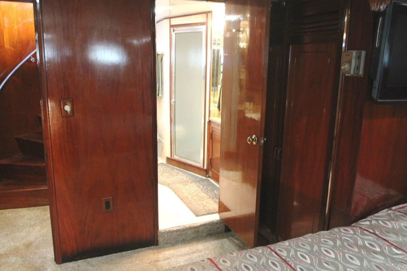 a room with a wood door and a mirror aboard ENCHANTRESS Yacht for Sale