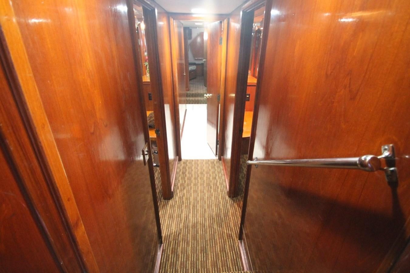 a hallway with wooden doors aboard ENCHANTRESS Yacht for Sale