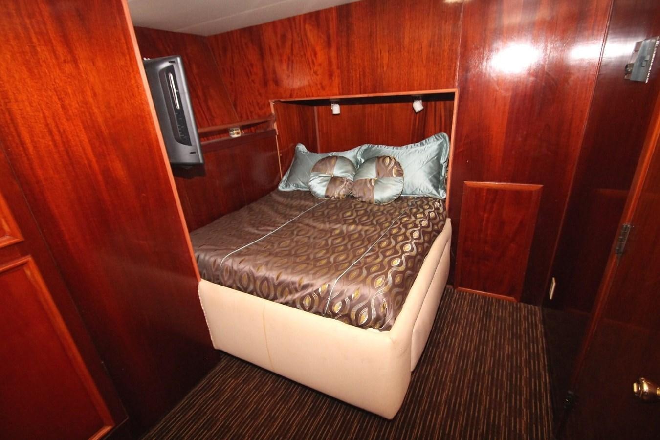 a bed with a pillow on it aboard ENCHANTRESS Yacht for Sale