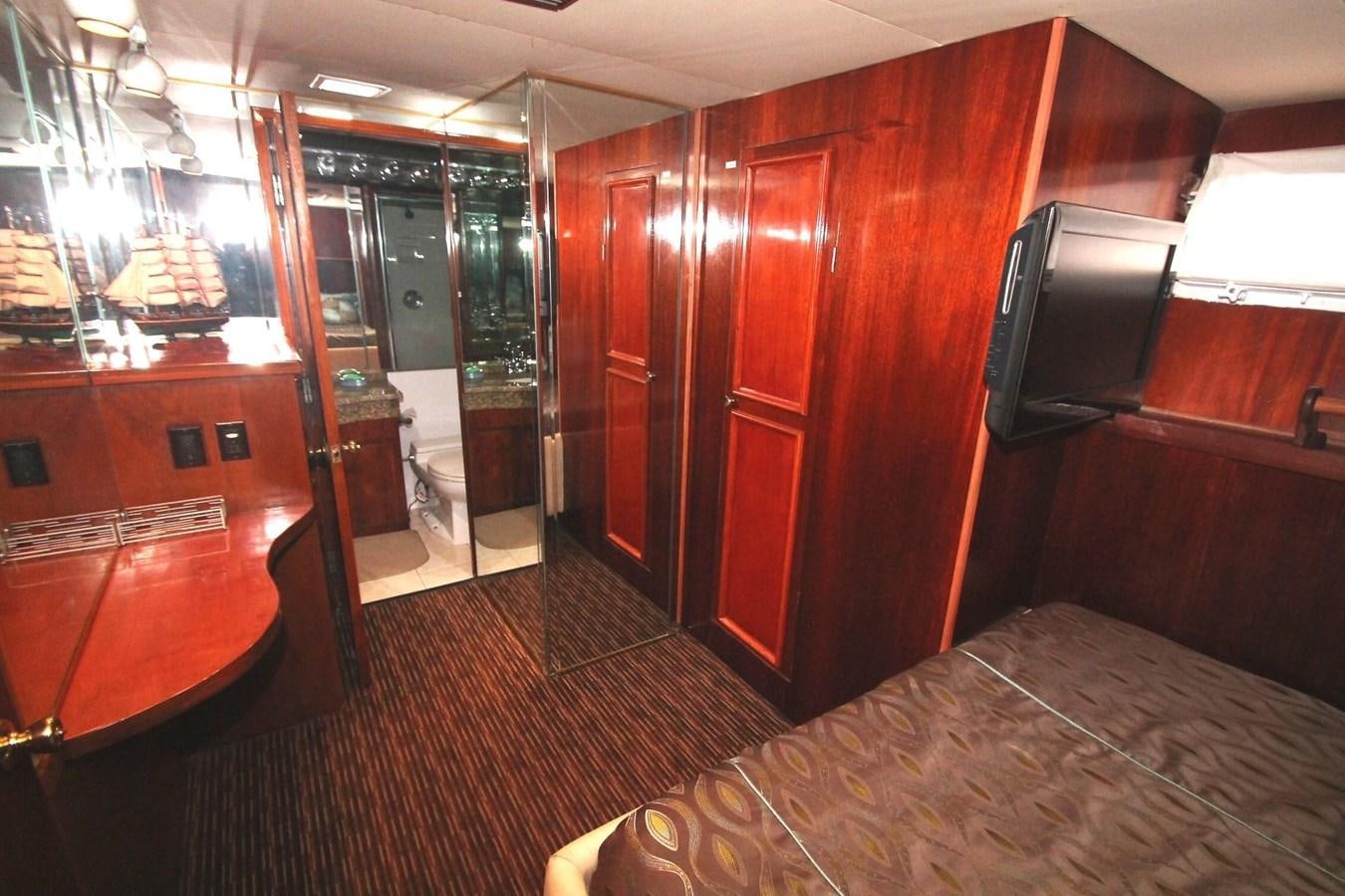 a room with a table and tv aboard ENCHANTRESS Yacht for Sale